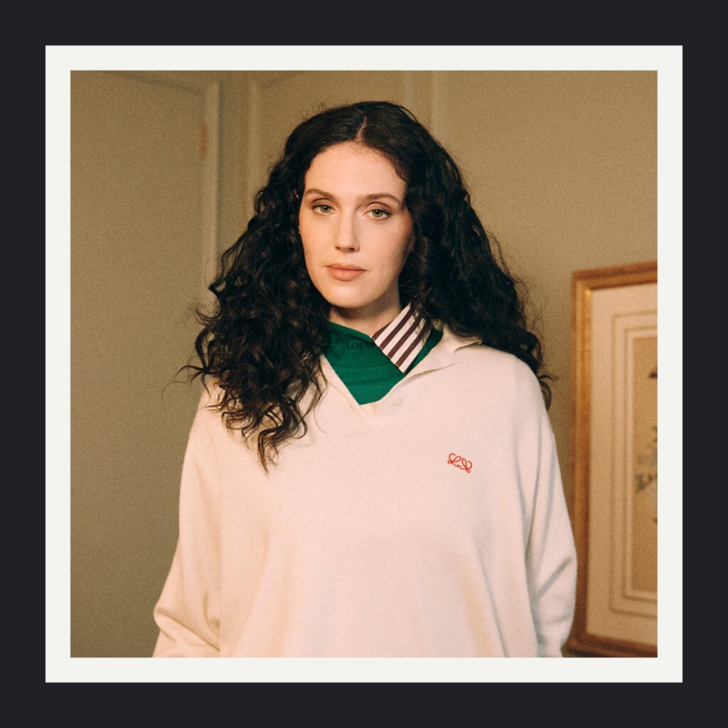 Eva Victor closeup of hair with natural curls and movement.