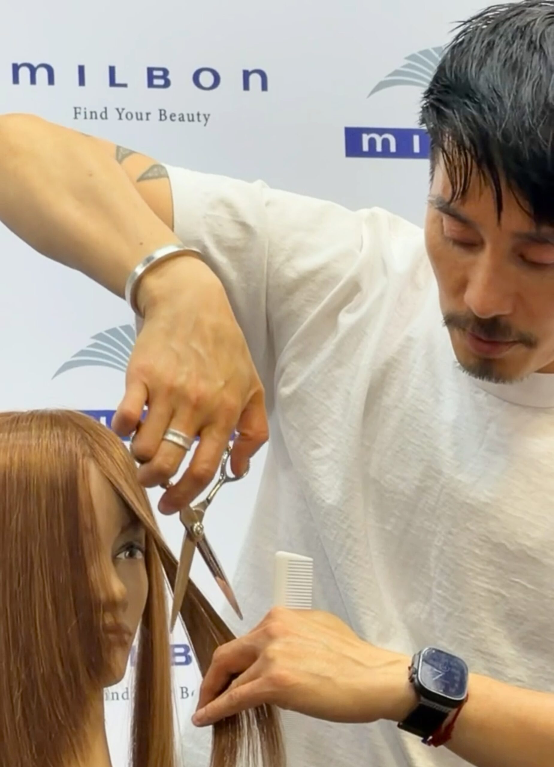Anh Co Tran demonstrating cutting techniques at Milbon Education Event