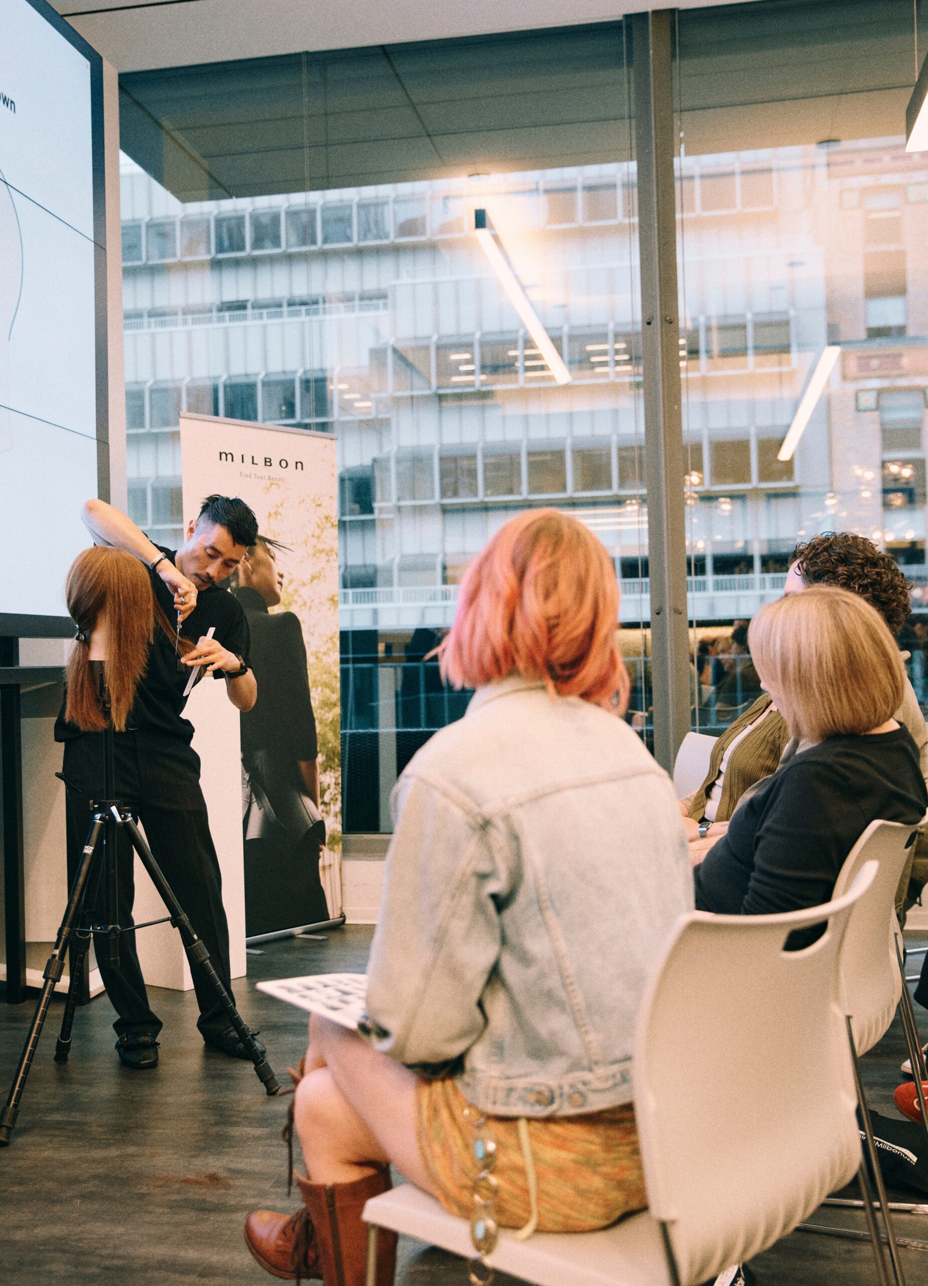 Professional hairstylists attending a Curated Cutting education class instructed by Anh Co Tran